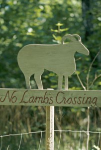 A detail of a country sign with carved figure of a ram,